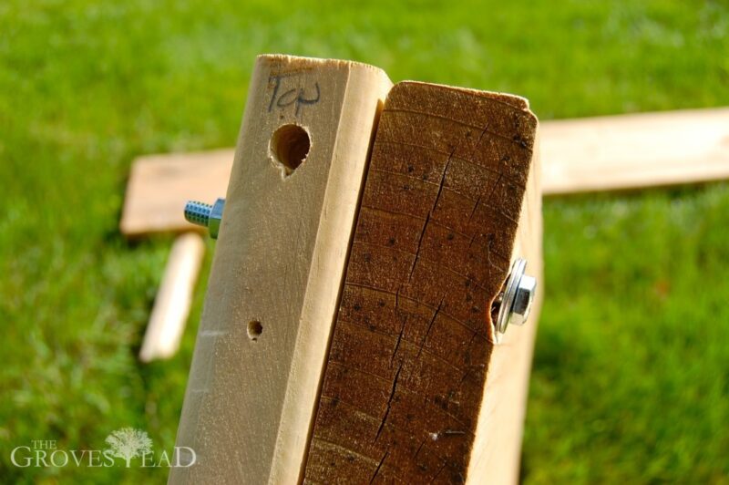 Stake and board of raised bed bolted together