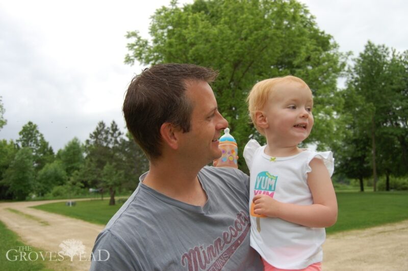 Elsie with daddy watching the tractor