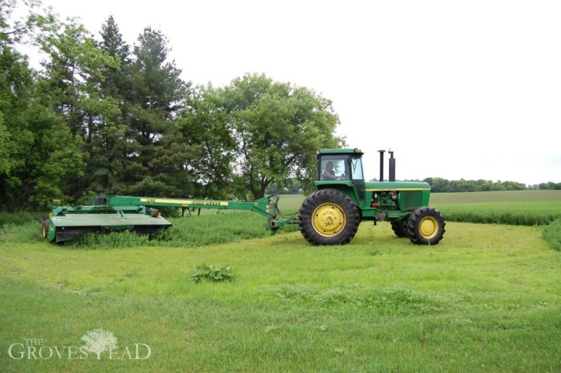 John Deere tractor cutting our hay field