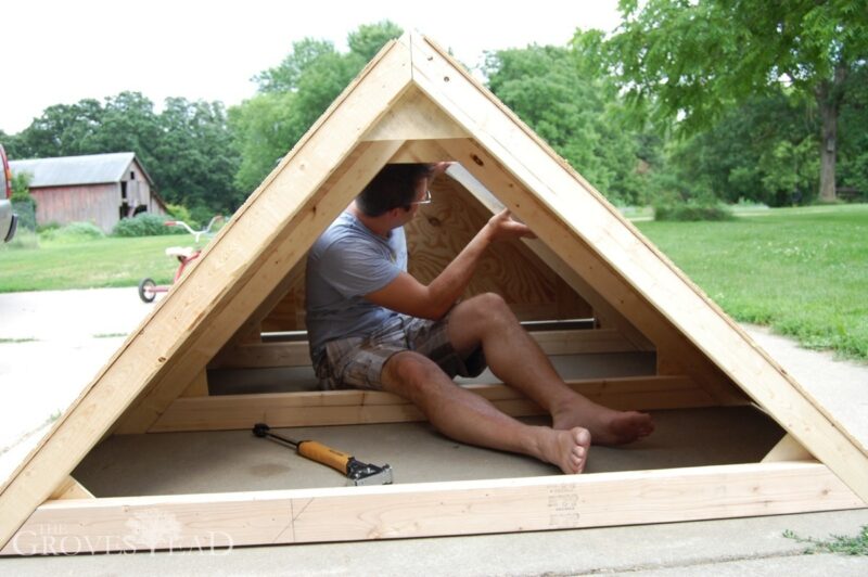 Installing hardware cloth over the window hatches on our mobile chicken coop