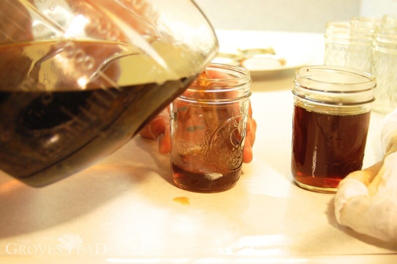 Pouring filtered maple syrup into jars