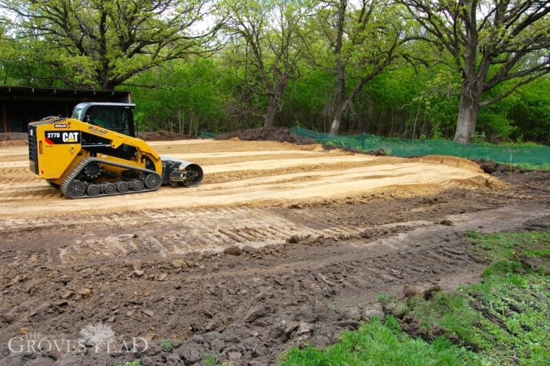 Skid loader smoothes out clay pad