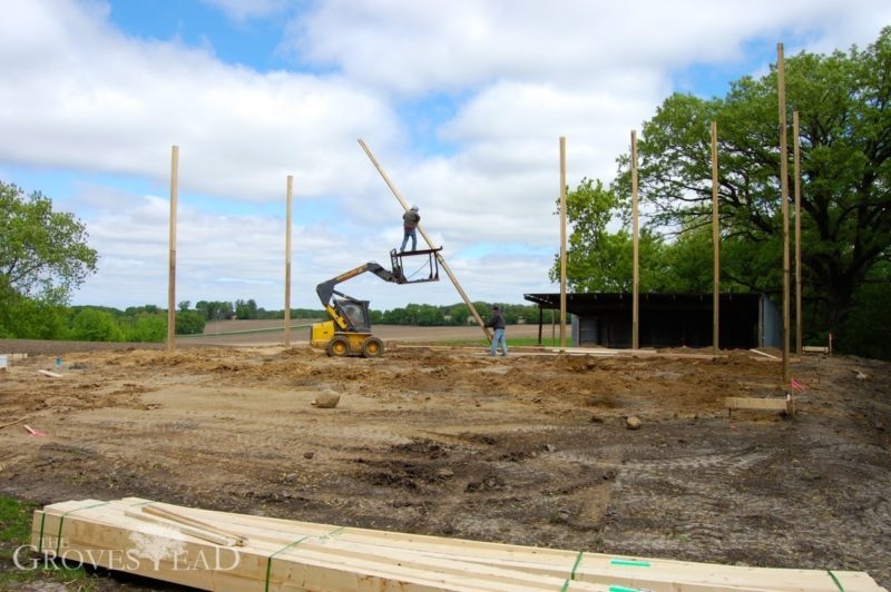 Workers place posts in ground